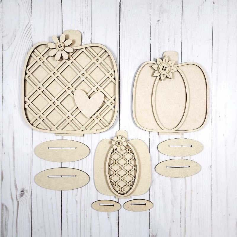 Wooden decorative pumpkins on a wooden background