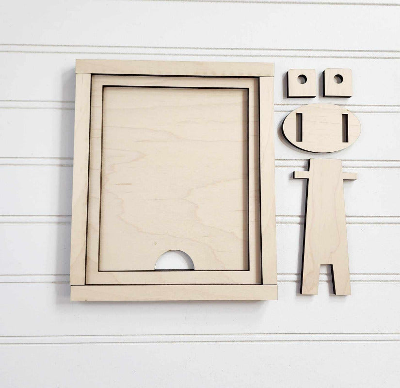 Wooden frame and decorative letters on a light wooden background